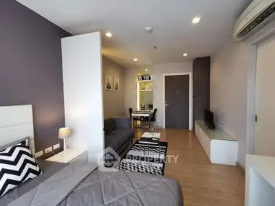 Modern studio apartment with stylish decor and open layout, featuring cozy living area and dining space.