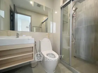 Modern bathroom with sleek shower and contemporary fixtures in a stylish apartment.