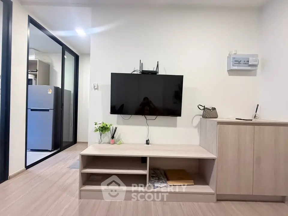 Modern living room with wall-mounted TV and sleek wooden furniture