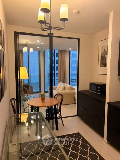 Modern apartment interior with stylish dining area and cozy living room, featuring elegant lighting and city view.