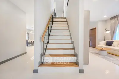 Modern interior with wooden staircase and elegant living room