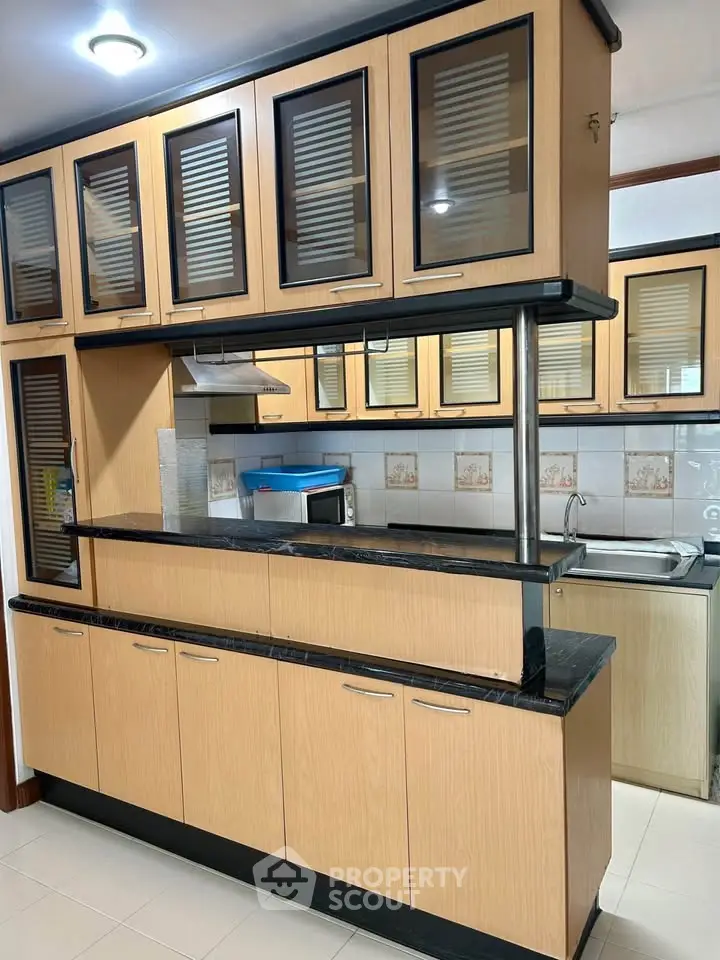 Modern kitchen with sleek wooden cabinets and open layout design