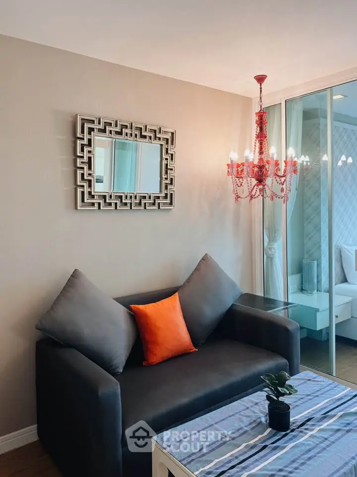 Stylish living room with modern decor and elegant chandelier, perfect for cozy relaxation.
