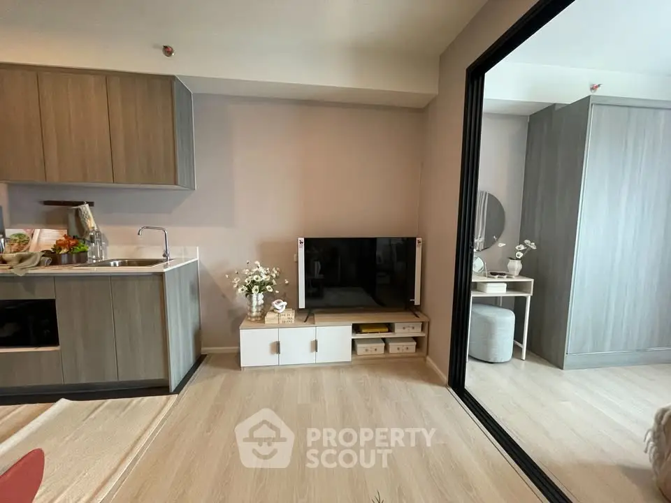 Modern living room with sleek kitchen and stylish decor