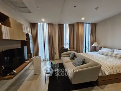 Modern studio apartment with stylish decor and large windows