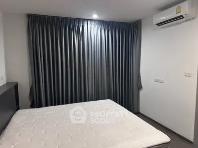 Spacious bedroom with modern air conditioning and elegant curtains