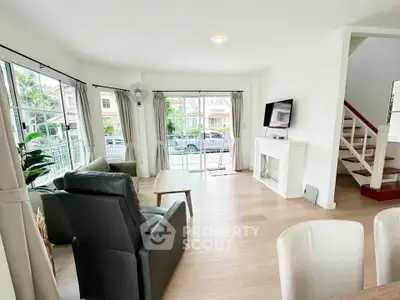 Spacious living room with modern decor and large windows offering natural light.
