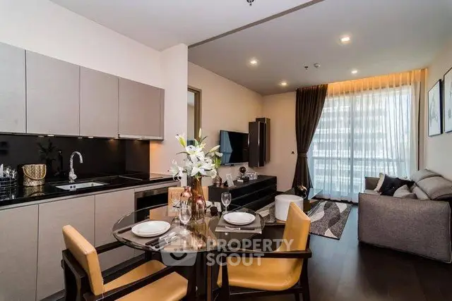 Modern open-plan kitchen and living room with stylish decor and natural light.