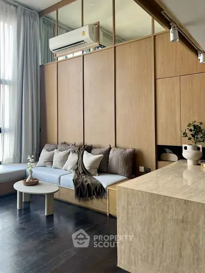 Modern living room with elegant wood paneling and cozy seating area