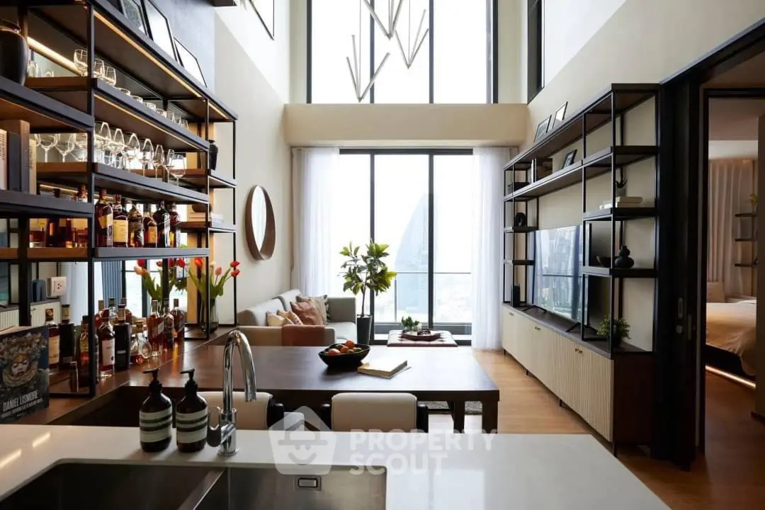 Luxurious modern living room with high ceilings, large windows, and elegant decor in a stylish apartment.