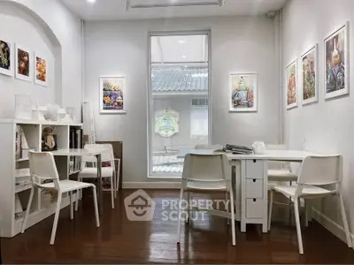Charming study room with modern white furniture and artistic wall decor.