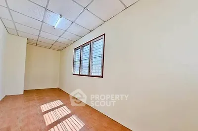 Spacious empty room with natural light and tiled flooring