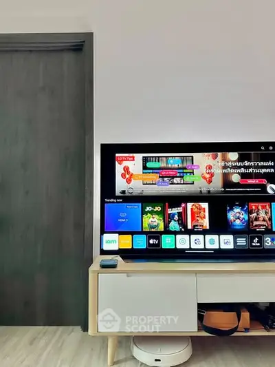 Modern living room with sleek TV setup and stylish wooden cabinet.