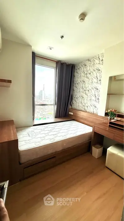 Modern bedroom with city view, featuring stylish wood furniture and large window for natural light.