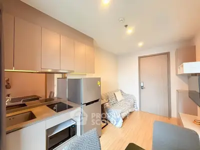 Modern compact apartment with sleek kitchen and cozy living area