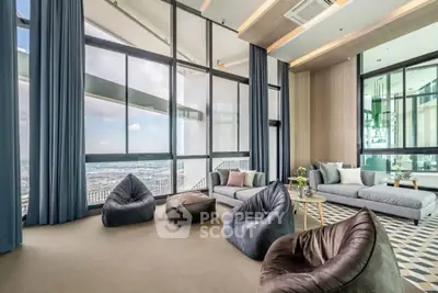 Luxurious high-rise living room with floor-to-ceiling windows and stunning city views.