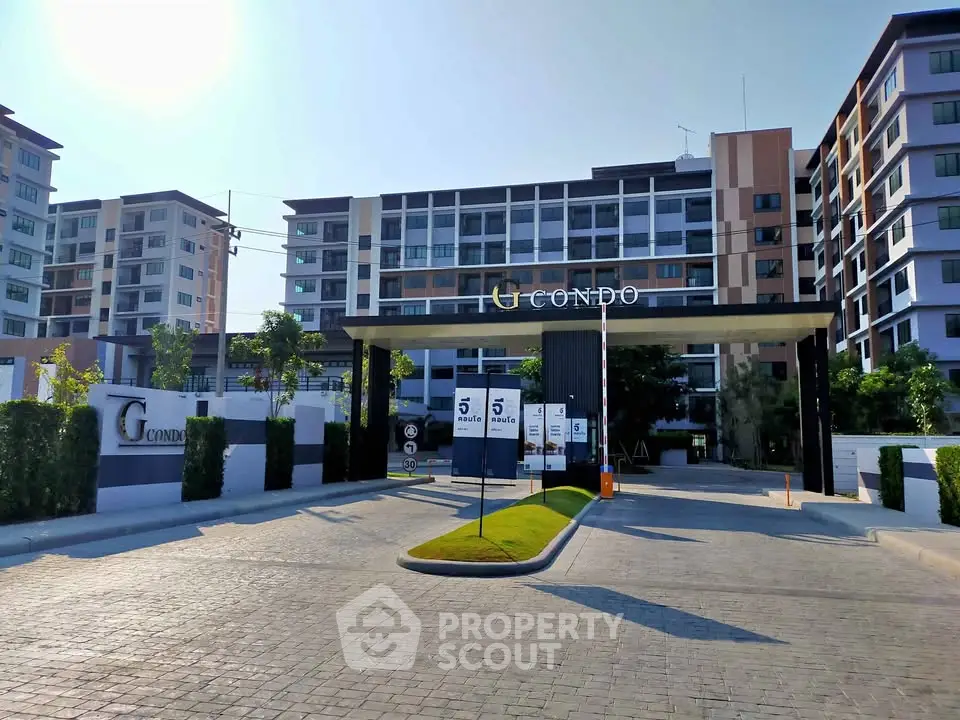 Modern condominium entrance with sleek design and lush landscaping, showcasing urban living at its finest.