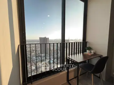 Stunning high-rise apartment with breathtaking city view from private balcony, perfect for relaxation and inspiration.