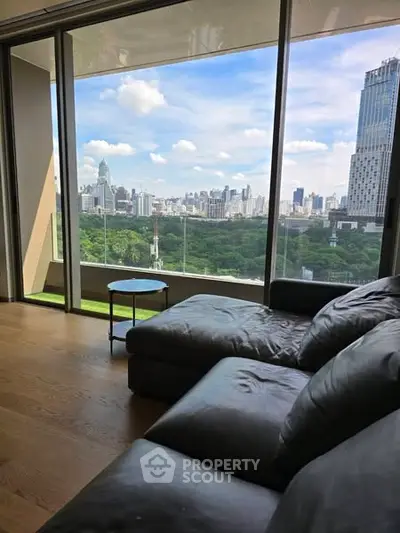 Luxurious living room with stunning city skyline view from large windows.