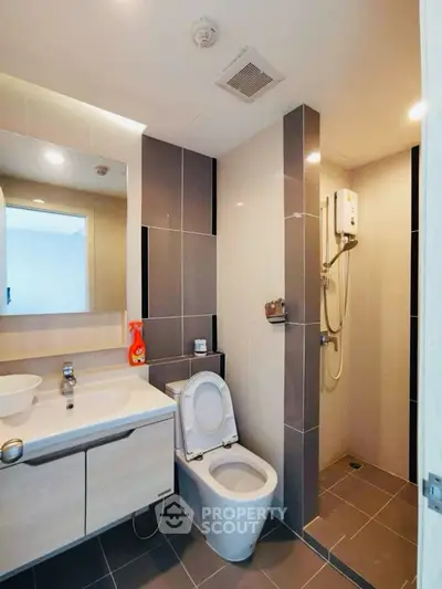 Modern bathroom with sleek design and shower area in a contemporary apartment.