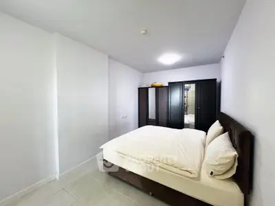 Spacious bedroom with modern furniture and ample storage space