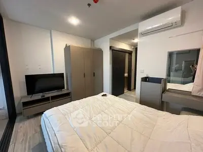 Cozy modern bedroom with air conditioning and stylish furnishings.