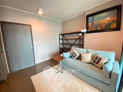 Cozy living room with modern decor and comfortable seating in a stylish apartment.