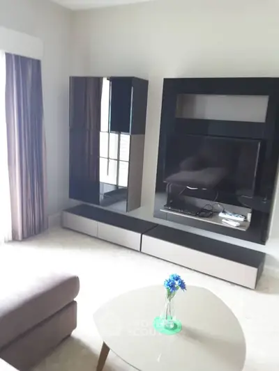 Modern living room with sleek entertainment center and cozy sofa