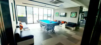 Luxurious common area with pool table and city view in modern building