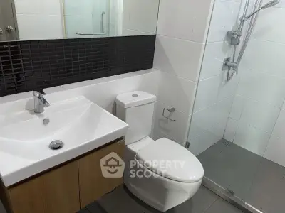 Modern bathroom with sleek fixtures and glass shower enclosure