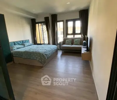 Spacious bedroom with modern decor and natural light