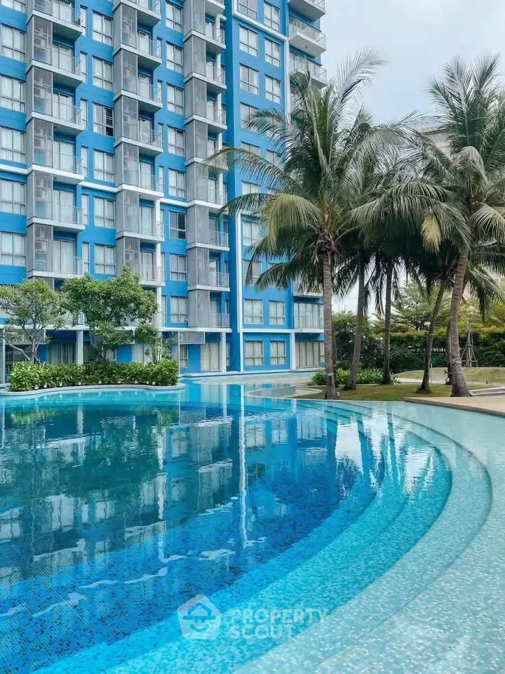 Luxurious residential building with stunning pool and lush palm trees