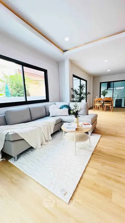 Spacious modern living room with large windows and stylish decor