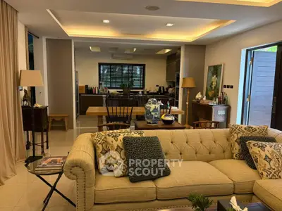 Luxurious open-plan living room with elegant decor and spacious kitchen area, perfect for modern living.