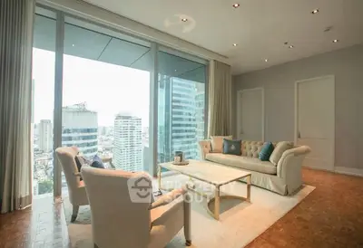 Luxurious living room with panoramic city view and elegant furnishings.