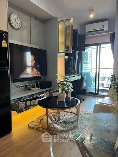 Modern living room with balcony view, stylish decor, and entertainment setup.