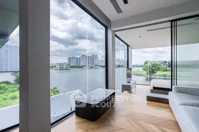 Luxurious modern living room with stunning river view and floor-to-ceiling windows