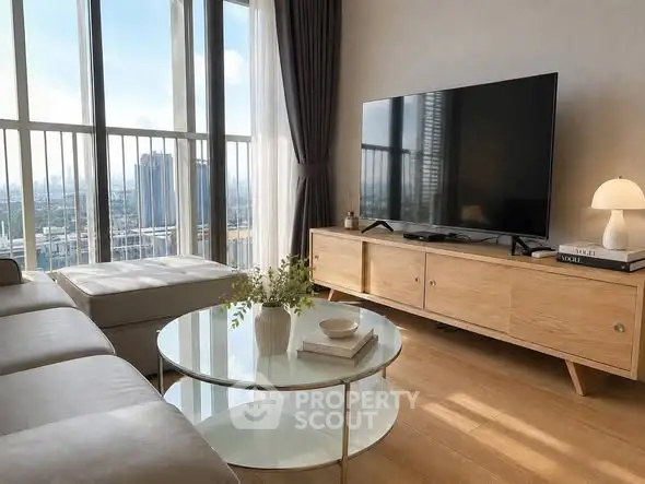 Modern living room with large windows and city view, featuring stylish furniture and decor.