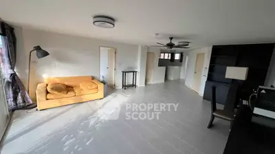 Spacious living room with modern decor and ample natural light