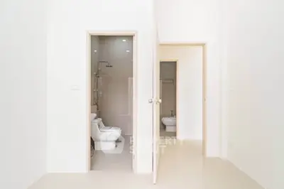 Minimalist bathroom with modern fixtures and sleek design in a bright, white interior.