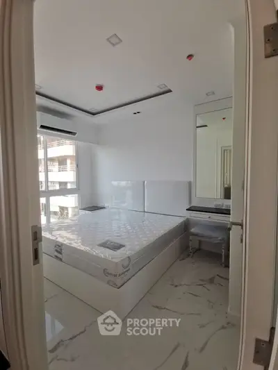 Modern bedroom with sleek design and large window for natural light