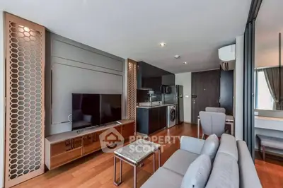 Modern living room with sleek furniture and integrated kitchen appliances in a stylish apartment.