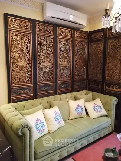 Luxurious living room with ornate wooden panels and elegant green sofa, perfect for sophisticated interiors.