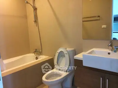 Modern bathroom with bathtub and sleek fixtures in a contemporary apartment.