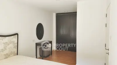 Spacious bedroom with modern decor and ample closet space