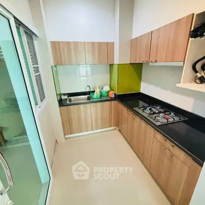 Modern kitchen with sleek cabinetry and gas stove in a compact layout