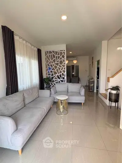 Spacious modern living room with stylish decor and natural light