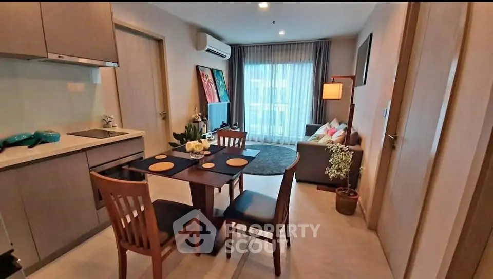 Modern open-plan living room with dining area and kitchen in cozy apartment