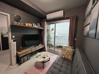 Cozy living room with balcony view, modern decor, and air conditioning.