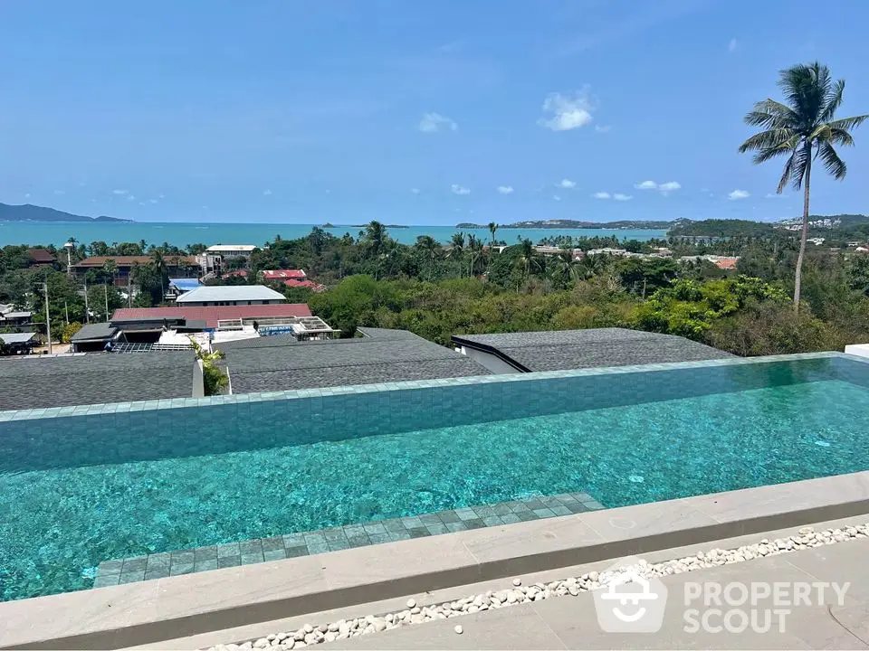 Stunning infinity pool with breathtaking ocean view and lush greenery surroundings.